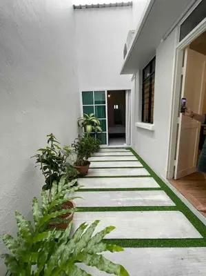a hallway of a building with plants on it at Modern Victorian Homestay in George Town