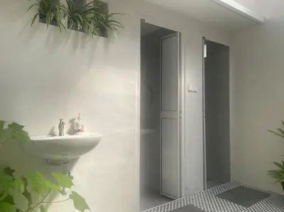 a white bathroom with a sink and a mirror at Modern Victorian Homestay in George Town