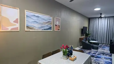 a dining room with a table with flowers on it at Humaira Homestay Teluk Intan in Teluk Intan