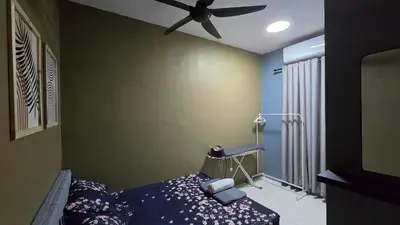 a bedroom with a bed and a ceiling fan at Humaira Homestay Teluk Intan in Teluk Intan