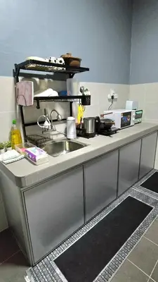 a kitchen with a sink and a counter top at Humaira Homestay Teluk Intan in Teluk Intan