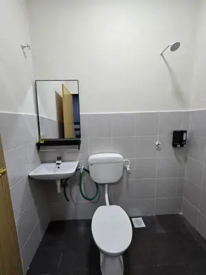 a bathroom with a toilet and a sink at Humaira Homestay Teluk Intan in Teluk Intan