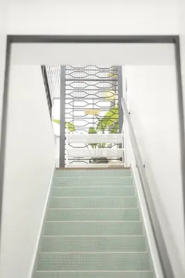 a staircase leading up to a building with green stairs at Suites Only KKB in Kuala Kubu Baharu