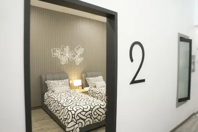 a room with two beds and a window with the number at Suites Only KKB in Kuala Kubu Baharu