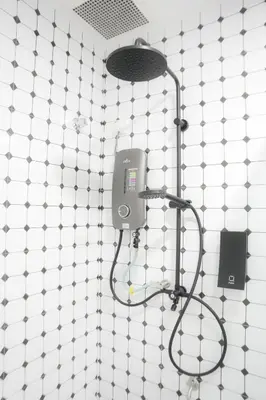 a shower in a bathroom with a shower head at Suites Only KKB in Kuala Kubu Baharu