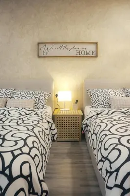 a bedroom with two beds and a sign on the wall at Suites Only KKB in Kuala Kubu Baharu