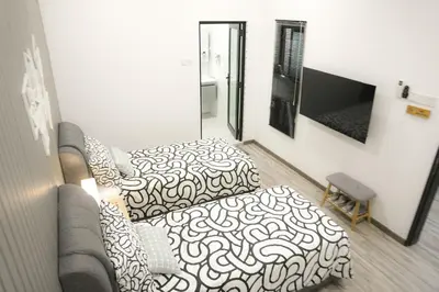 a living room with a couch and a flat screen tv at Suites Only KKB in Kuala Kubu Baharu