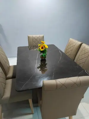 a table with a vase with a flower on it at Homestay Lyn Impian in Tanjung Rambutan