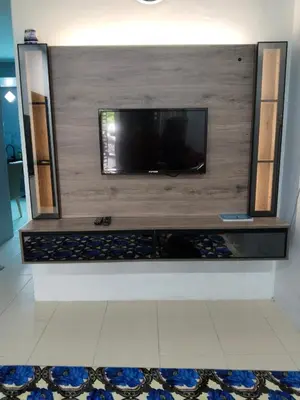 a flat screen tv on a wall in a room at Homestay Lyn Impian in Tanjung Rambutan