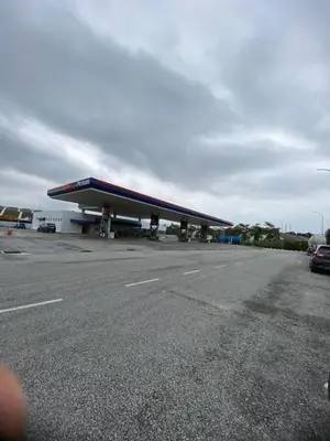 a view of a gas station with a building at Homestay Lyn Impian in Tanjung Rambutan