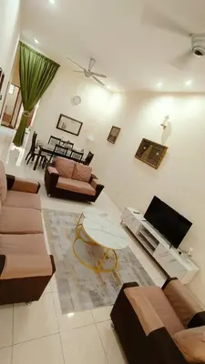 a living room with couches and a table at Musa Seri Iskandar Homestay in Seri Iskandar