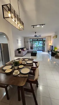 a living room with a wooden table and a couch at Noble Villa Condo Georgetown City Center Macalister 3 Bedroom 3 Carpark in George Town