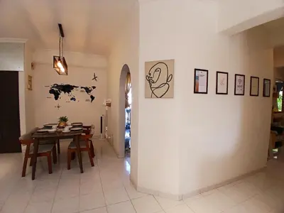 a dining room with a table and a white wall at Noble Villa Condo Georgetown City Center Macalister 3 Bedroom 3 Carpark in George Town