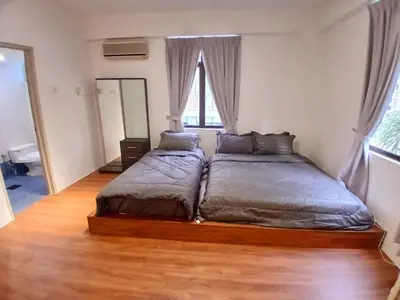 a bedroom with two beds and a wooden floor at Noble Villa Condo Georgetown City Center Macalister 3 Bedroom 3 Carpark in George Town