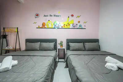 two beds sitting next to each other in a room at Luxury Pokémon Haven with Private Playground Brinchang Cameron Highlands Clover Home 2-28 in Brinchang