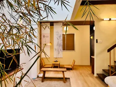 a living room with a bench and a table at New Takekaze Retreat \u7af9\u98ce\u4e4b\u5bb6 for 14 pax at Central Penang in George Town