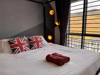 a bed with a red towel on top of it at Cameron Golden Hills Near Night Market CH1 in Brinchang