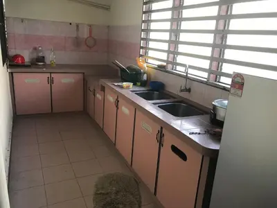 a kitchen with a sink and a counter top at 3999 Sejahtera Homestay in Lunas