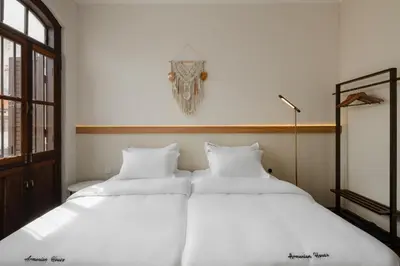 two beds sitting next to each other in a bedroom at Armenian House by IIP in George Town