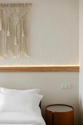 a bedroom with a white bed and a wooden table at Armenian House by IIP in George Town