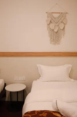 a bedroom with a white bed and a table at Armenian House by IIP in George Town