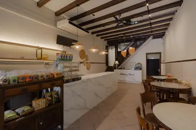 a restaurant with two tables and chairs and a counter at Armenian House by IIP in George Town