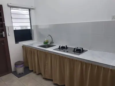 a kitchen with a counter with a sink and a window at Nufa homestay-seri iskandar in Seri Iskandar