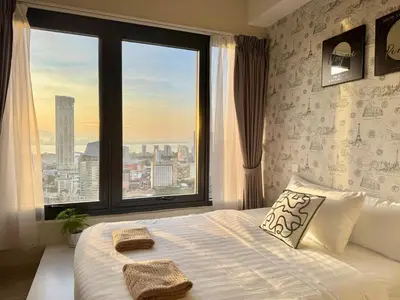 a bedroom with a large bed with a large window at Tropicana 218 Macalister #Georgetown #Infinity Pool #2pax studio suite #1 Queen #Quality well maintained #Private host in George Town
