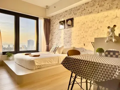 a bedroom with a bed and a table in it at Tropicana 218 Macalister #Georgetown #Infinity Pool #2pax studio suite #1 Queen #Quality well maintained #Private host in George Town