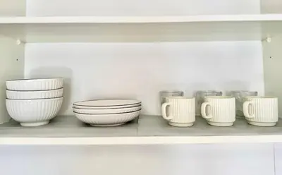 a row of white bowls and jars on a shelf at Tropicana 218 Macalister #Georgetown #Infinity Pool #2pax studio suite #1 Queen #Quality well maintained #Private host in George Town