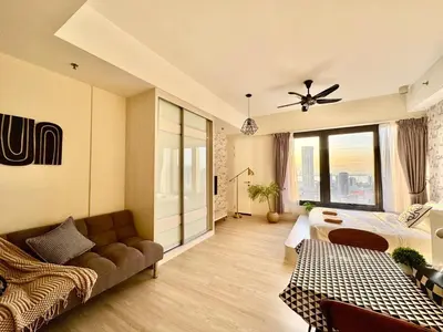 a living room with a bed and a couch at Tropicana 218 Macalister #Georgetown #Infinity Pool #2pax studio suite #1 Queen #Quality well maintained #Private host in George Town