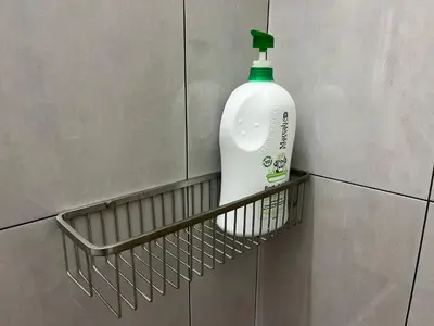 a large bottle of detergent sitting on a rack on a wall at Green Woody Homestay in Ipoh