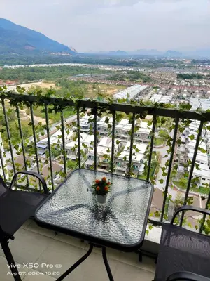 a table with a potted plant on top of a balcony at Residensi Meru Raya in Ipoh