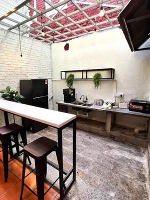 a kitchen with a counter and a table and chairs at Pine Muntri in George Town