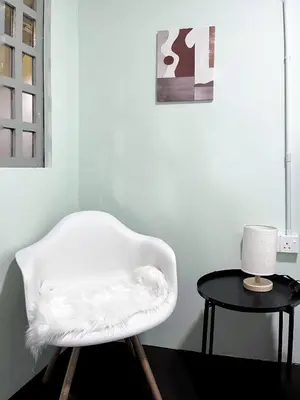 a white chair sitting next to a table at Pine Muntri in George Town