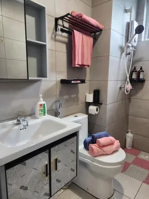 a bathroom with a white sink and a toilet at CATAILIS Metropol Serviced Apartment Bandar Perda Bukit Mertajam near Penang Bridge in Bukit Mertajam