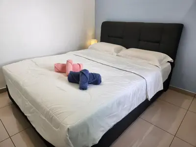 a large bed with two stuffed animals on it at CATAILIS Metropol Serviced Apartment Bandar Perda Bukit Mertajam near Penang Bridge in Bukit Mertajam