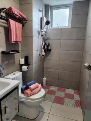 a bathroom with a toilet and a sink and a window at CATAILIS Metropol Serviced Apartment Bandar Perda Bukit Mertajam near Penang Bridge in Bukit Mertajam