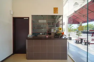 a kitchen with a counter in a building at CMN Hotel & Homestay in Sungai Petani