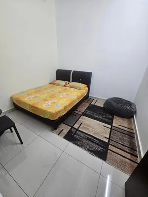 a bed sitting on a floor in a room at alif homestay kulim in Kulim