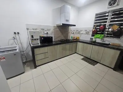 a kitchen with a sink and a stove top oven at alif homestay kulim in Kulim