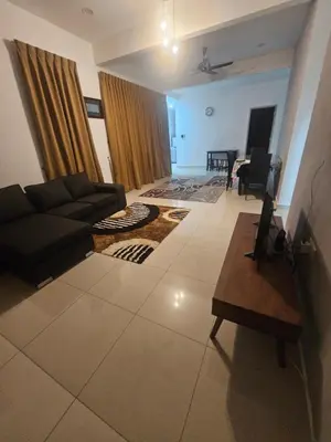 a living room with a couch and a table at alif homestay kulim in Kulim