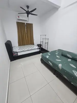 a room with two beds and a ceiling fan at alif homestay kulim in Kulim