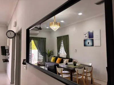 a living room with a table and a couch at Lodging Mak Endon in Seri Manjung