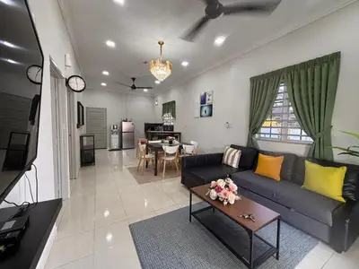 a living room with a couch and a table at Lodging Mak Endon in Seri Manjung
