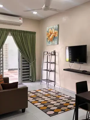 a living room with a flat screen tv on the wall at Lodging Mak Endon in Seri Manjung