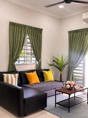 a living room with a couch and a table at Lodging Mak Endon in Seri Manjung