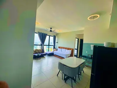 a living room with a table and a couch at cozy 3BR family suites 10pax in Jelutong