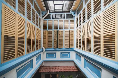 an empty building with wooden windows and a ceiling at My Guesthouse 109 - SELF CHECK IN in George Town