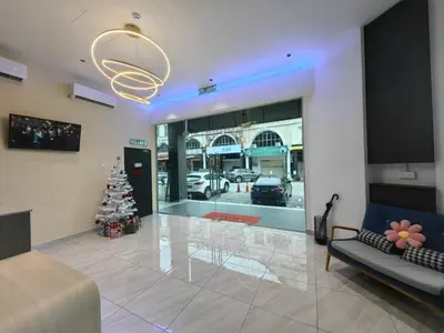 a living room with a christmas tree in front of a store at Galaxy Hotel Bandar Perda in Bukit Mertajam